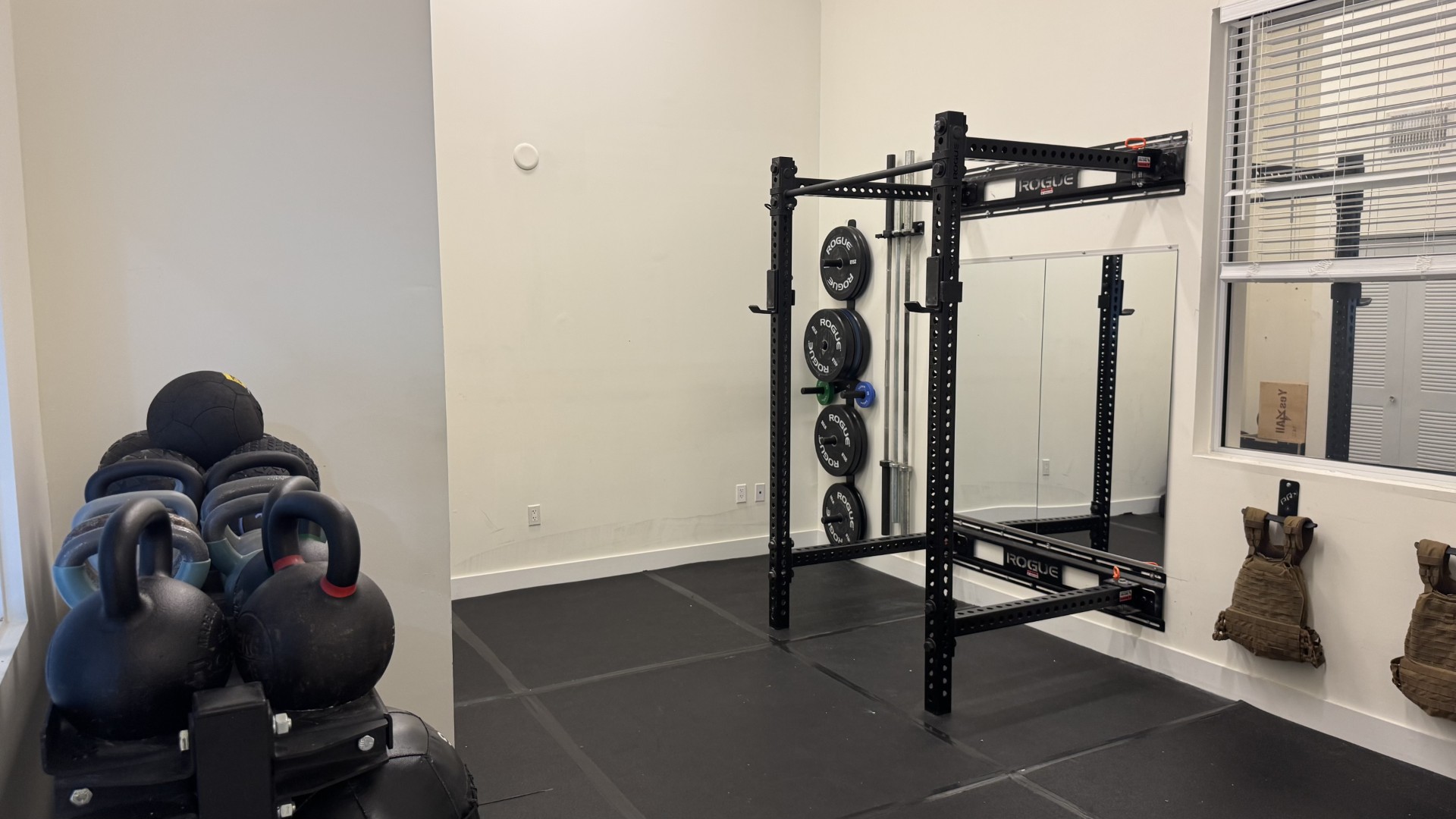 Squat rack, plates and kettlebells in the strength area